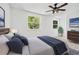 Bedroom with plush carpet, ceiling fan, and two bright windows at 5180 Stone Trce, Stone Mountain, GA 30083