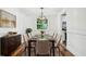 Elegant dining room with wood floors, modern light fixture, and seating for eight at 5180 Stone Trce, Stone Mountain, GA 30083