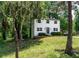 Two-story home nestled among mature trees, with fresh white paint at 5180 Stone Trce, Stone Mountain, GA 30083