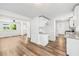 Bright open-concept kitchen and dining area with hardwood floors and white cabinets at 5180 Stone Trce, Stone Mountain, GA 30083