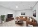 Staged living room featuring brown leather sofas and a large coffee table at 5180 Stone Trce, Stone Mountain, GA 30083