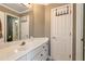 Bright bathroom featuring a white vanity, a large mirror, and a door to the walk-in closet at 1485 Mill Place Dr, Dacula, GA 30019