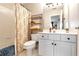 Well-lit bathroom featuring a white vanity and a shower with a patterned curtain at 1485 Mill Place Dr, Dacula, GA 30019