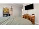 Cozy bedroom with wood desk, decorative art, and a mounted TV at 1485 Mill Place Dr, Dacula, GA 30019
