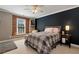 This charming bedroom features a brick accent wall, window seat, and neutral decor at 1485 Mill Place Dr, Dacula, GA 30019