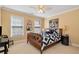 Cozy bedroom with a ceiling fan, natural light from the window, and fun wall art at 1485 Mill Place Dr, Dacula, GA 30019