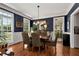 Sophisticated dining room with navy walls, hardwood floors, and ample natural light for elegant gatherings at 1485 Mill Place Dr, Dacula, GA 30019