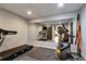 Mirrored exercise room with modern fitness equipment and rubber flooring at 1485 Mill Place Dr, Dacula, GA 30019