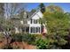 Beautiful two-story white home featuring classic architecture, lush greenery, and a well-maintained front yard at 1485 Mill Place Dr, Dacula, GA 30019