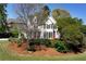 Charming two-story home with a manicured lawn, lush landscaping, and a welcoming red front door at 1485 Mill Place Dr, Dacula, GA 30019
