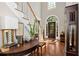 Elegant foyer featuring hardwood floors, a staircase with white railings, and a striking arched doorway at 1485 Mill Place Dr, Dacula, GA 30019