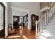 Spacious foyer with hardwood floors, staircase, and a view into the dining room, perfect for welcoming guests at 1485 Mill Place Dr, Dacula, GA 30019