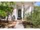 Charming front entrance with a black door, surrounded by lush greenery and manicured landscaping at 1485 Mill Place Dr, Dacula, GA 30019