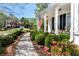 Beautiful home exterior with manicured lawn, flowering plants, and American flag at 1485 Mill Place Dr, Dacula, GA 30019