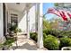 Welcoming front porch with an American flag, chairs, and well-maintained landscaping at 1485 Mill Place Dr, Dacula, GA 30019