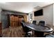 Spacious game room with poker table, hardwood floors, a flat-screen TV, and a built-in wooden cabinet at 1485 Mill Place Dr, Dacula, GA 30019