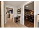 Hallway with tile flooring and a view of an office and exercise room at 1485 Mill Place Dr, Dacula, GA 30019