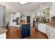 Bright kitchen with island, granite countertops, stainless appliances, and large windows at 1485 Mill Place Dr, Dacula, GA 30019