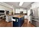 Kitchen featuring a blue island, stainless steel appliances and stone backsplash at 1485 Mill Place Dr, Dacula, GA 30019