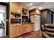 Kitchenette in finished basement features light wood cabinets and a microwave at 1485 Mill Place Dr, Dacula, GA 30019