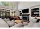 Bright living room with fireplace, built-ins, and high ceilings at 1485 Mill Place Dr, Dacula, GA 30019