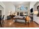 Bright living room boasts hardwood floors, high ceilings, and large windows offering plenty of natural light at 1485 Mill Place Dr, Dacula, GA 30019