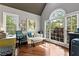 Bright home office with large windows, hardwood floors, and comfortable seating for a productive workspace at 1485 Mill Place Dr, Dacula, GA 30019