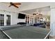 Spacious screened porch with a tv, slate floors, ceiling fans and furniture at 1485 Mill Place Dr, Dacula, GA 30019