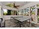 Light filled sunroom with a ping pong table and views of the trees outside at 1485 Mill Place Dr, Dacula, GA 30019