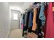 Walk-in closet with a window and custom storage solutions for organizing your wardrobe at 1485 Mill Place Dr, Dacula, GA 30019