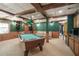 Spacious basement area with pool table, bar, and wood paneled walls at 1660 Maple Ridge Dr, Loganville, GA 30052