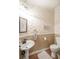 Charming half bath with decorative wallpaper, pedestal sink, and classic fixtures at 1660 Maple Ridge Dr, Loganville, GA 30052