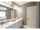 Elegant bathroom with double sinks, marble countertops, and white cabinetry at 1660 Maple Ridge Dr, Loganville, GA 30052
