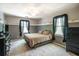 Bedroom with neutral carpet, two-tone paint, black curtains, and furniture at 1660 Maple Ridge Dr, Loganville, GA 30052