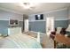 Spacious bedroom featuring gray and white tones, large mirror, and TV at 1660 Maple Ridge Dr, Loganville, GA 30052