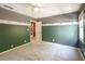 Spacious bedroom featuring two-tone paint, white trim, neutral carpet, and a ceiling fan at 1660 Maple Ridge Dr, Loganville, GA 30052