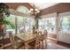 Cozy dining area with a large window, chandelier, and view of backyard at 1660 Maple Ridge Dr, Loganville, GA 30052