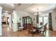 Elegant dining room with wainscoting, hardwood floors, and a chandelier over the dining table at 1660 Maple Ridge Dr, Loganville, GA 30052