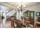 Formal dining room featuring hardwood floors, a large china cabinet, and a decorative chandelier at 1660 Maple Ridge Dr, Loganville, GA 30052