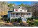 Inviting two-story home with a charming front porch, red shutters, and a well-maintained lawn at 1660 Maple Ridge Dr, Loganville, GA 30052