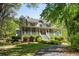 Two-story home with a spacious front porch and a scenic driveway surrounded by trees at 1660 Maple Ridge Dr, Loganville, GA 30052