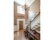 Elegant foyer with high ceilings, hardwood floors, and a grand staircase with decorative chandelier at 1660 Maple Ridge Dr, Loganville, GA 30052