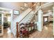 Foyer with hardwood floors, a staircase, and adjacent rooms visible through open doorways at 1660 Maple Ridge Dr, Loganville, GA 30052