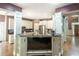 Modern kitchen with stainless steel appliances, dark countertops, and TV console at 1660 Maple Ridge Dr, Loganville, GA 30052
