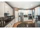 Well-equipped kitchen featuring stainless steel appliances, custom cabinets, and hardwood flooring at 1660 Maple Ridge Dr, Loganville, GA 30052