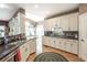Open kitchen with granite counters, wooden cabinets, stainless appliances, and an adjacent dining area at 1660 Maple Ridge Dr, Loganville, GA 30052