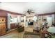 Open-concept living room with hardwood floors, ceiling fan, and decorative columns at 1660 Maple Ridge Dr, Loganville, GA 30052