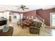 Comfortable living room featuring hardwood floors, ceiling fan, and traditional-style furniture at 1660 Maple Ridge Dr, Loganville, GA 30052