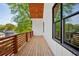 Outdoor balcony featuring hardwood floors, wood railing, and green tree views at 1882 Francis Nw Ave, Atlanta, GA 30318