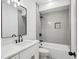 Bathroom featuring modern gray tile in shower/tub with black hardware and white marble vanity at 1882 Francis Nw Ave, Atlanta, GA 30318
